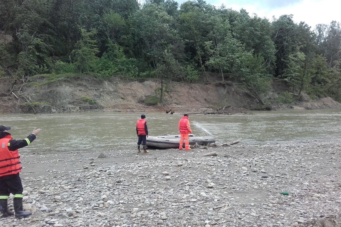 FOTO/VIDEO: Încercări disperate pentru găsirea tânărului înecat în râul Trotuș. Au fost chemați scafandrii și un tractor cu troliu