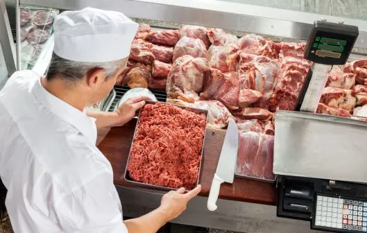 36433287 - butcher holding minced meat tray
